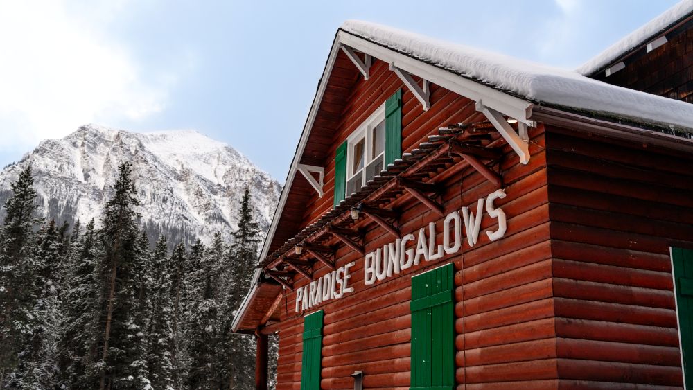 Paradise Bungalows Log Cabin in Winter with snowy Mount Temple in background